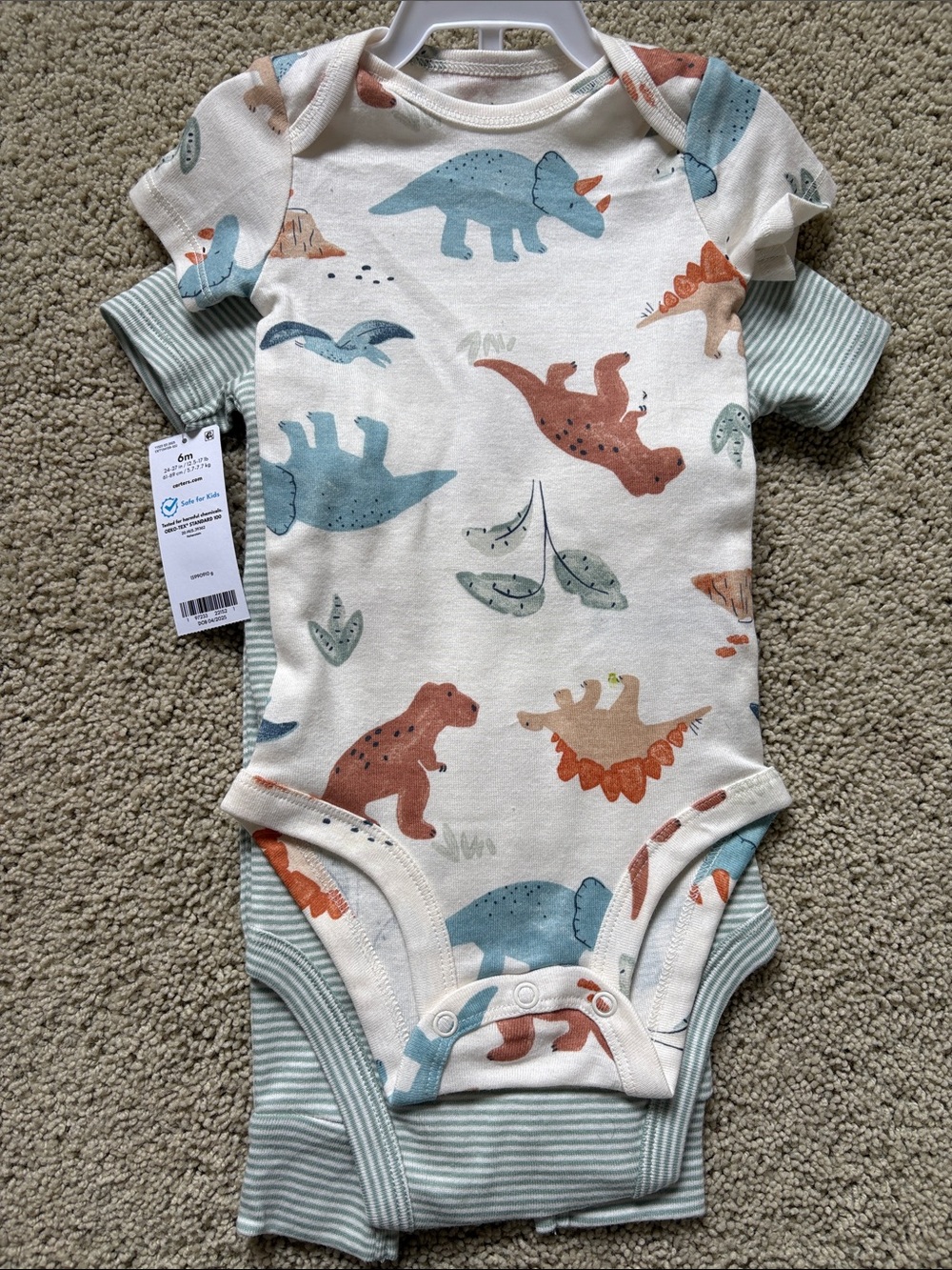 Carter’s Dino Print One-Piece Bodysuit in Cream & Blue- 6 months - new with tags